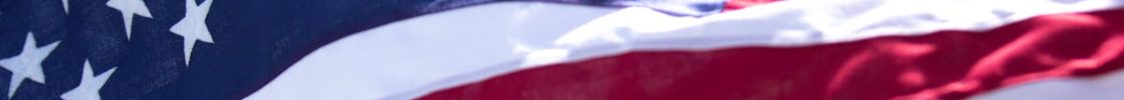 A detailed close-up of the American flag's stars and stripes fluttering against the sky.